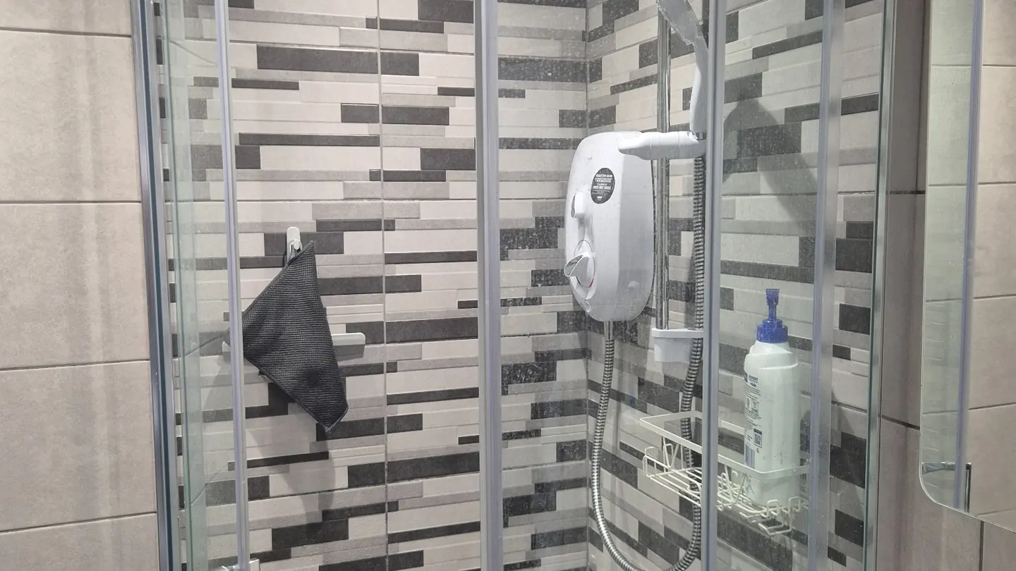 Shower enclosure and electric shower